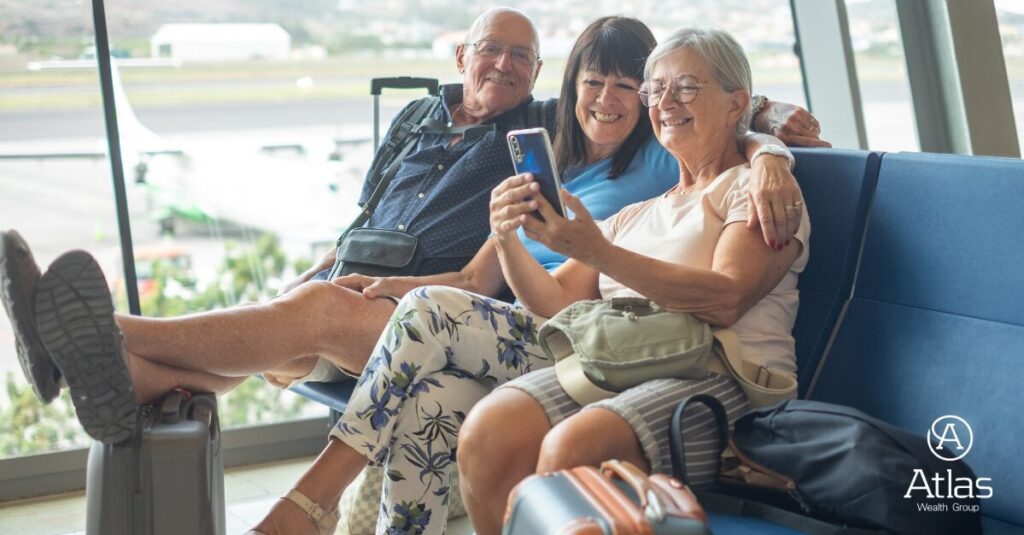 Group of seniors at airport looking at phone